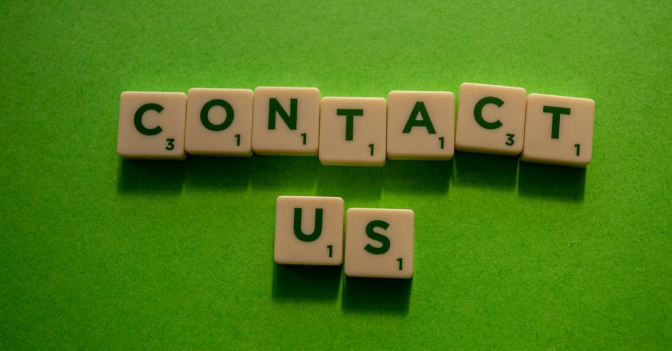 Scrabble game visual stating 'Contact Us'